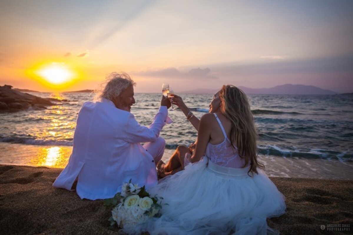 Romantic Mykonos Wedding Packages – Bride and Groom Toasting on the Beach at Sunset | Luxury Destination Wedding in Greece